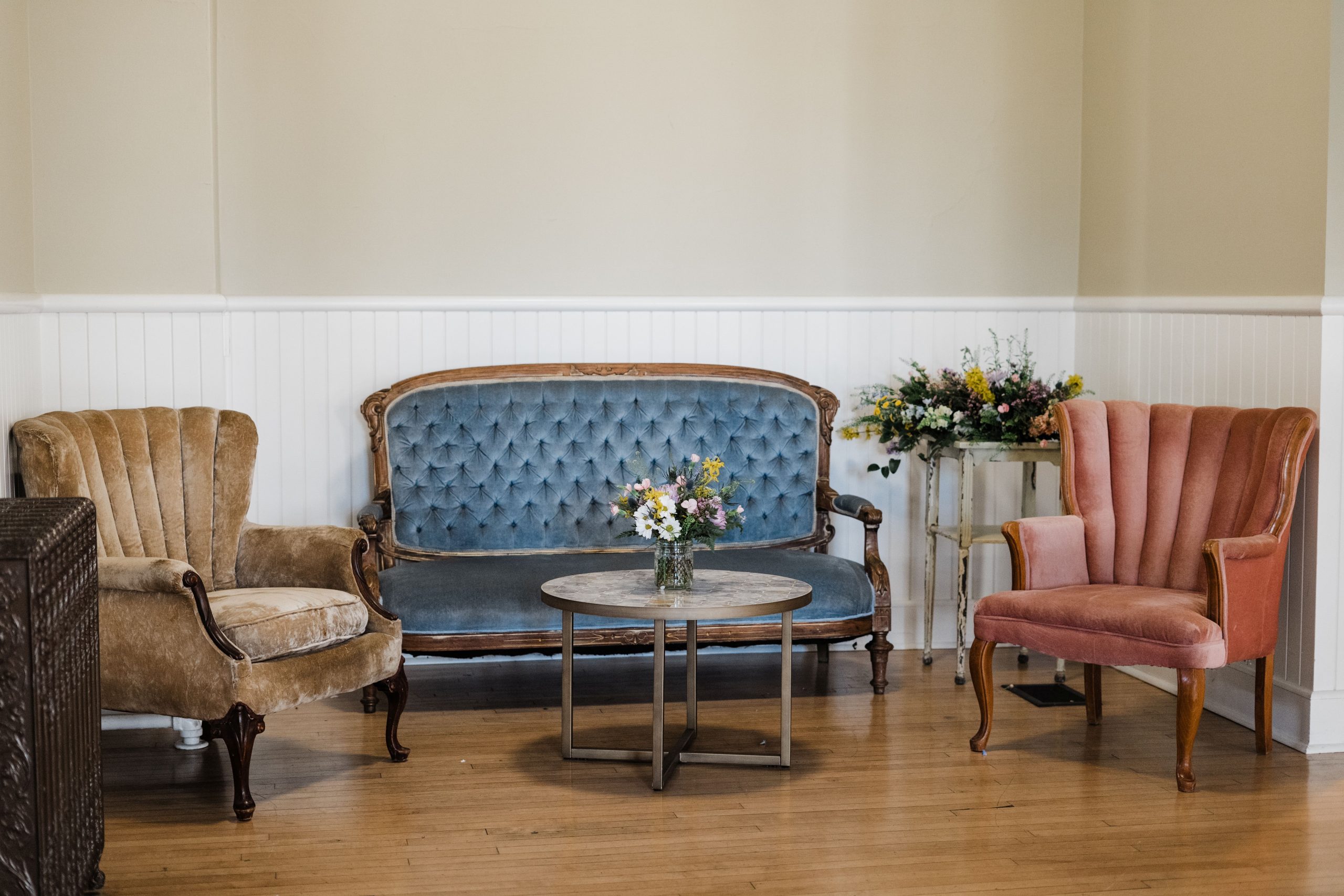 Amanda and Quintin Wedding Vintage furniture used for the wedding reception: gold tufted armchair, blue couch and dusty rose wingback chair