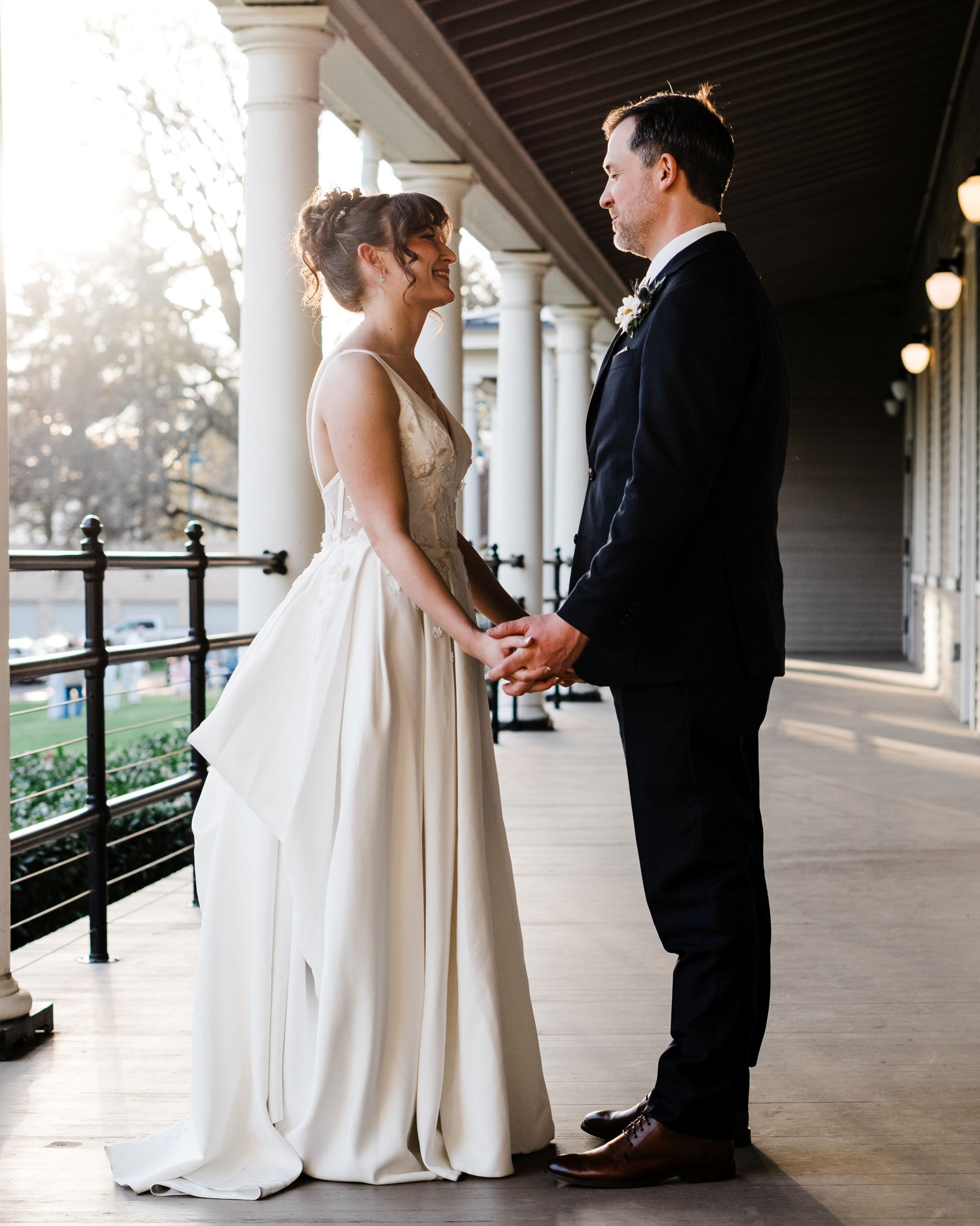 Amanda and Quintin Wedding Bride and groom posing together on the south porch of the Artillery Barracks