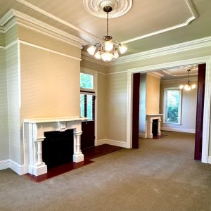 Living room with fireplace; chandelier with ceiling medallion