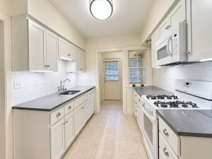 dx-523_kitchen Modern white kitchen with dark gray countertops in 523 Hatheway Rd